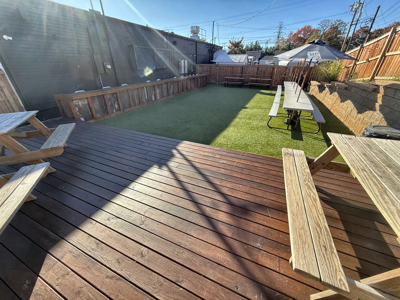 Sunny back deck with picnic tables looking out over the turf